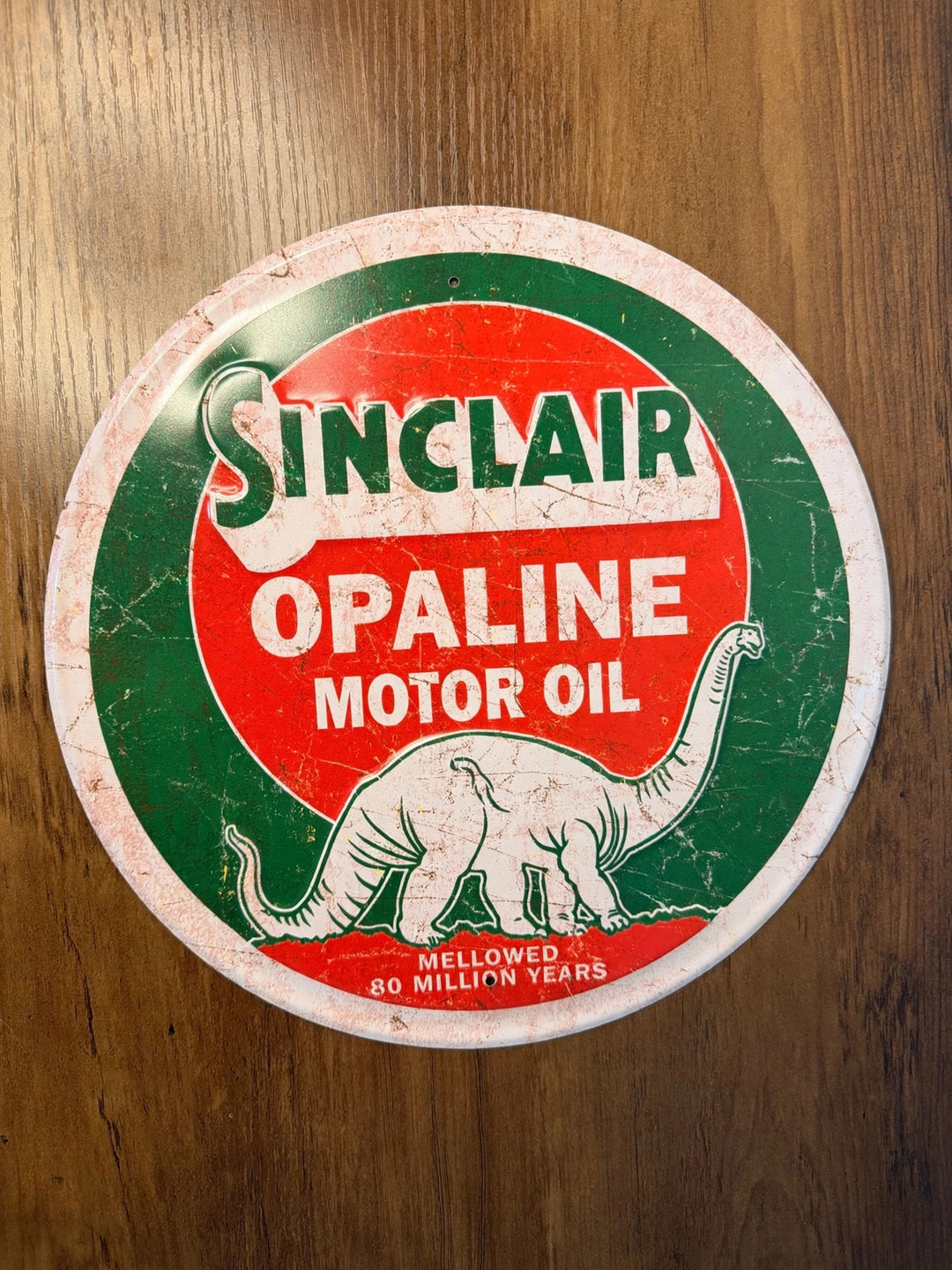 Sinclair Opaline Motor Oil round embossed metal sign with dinosaur