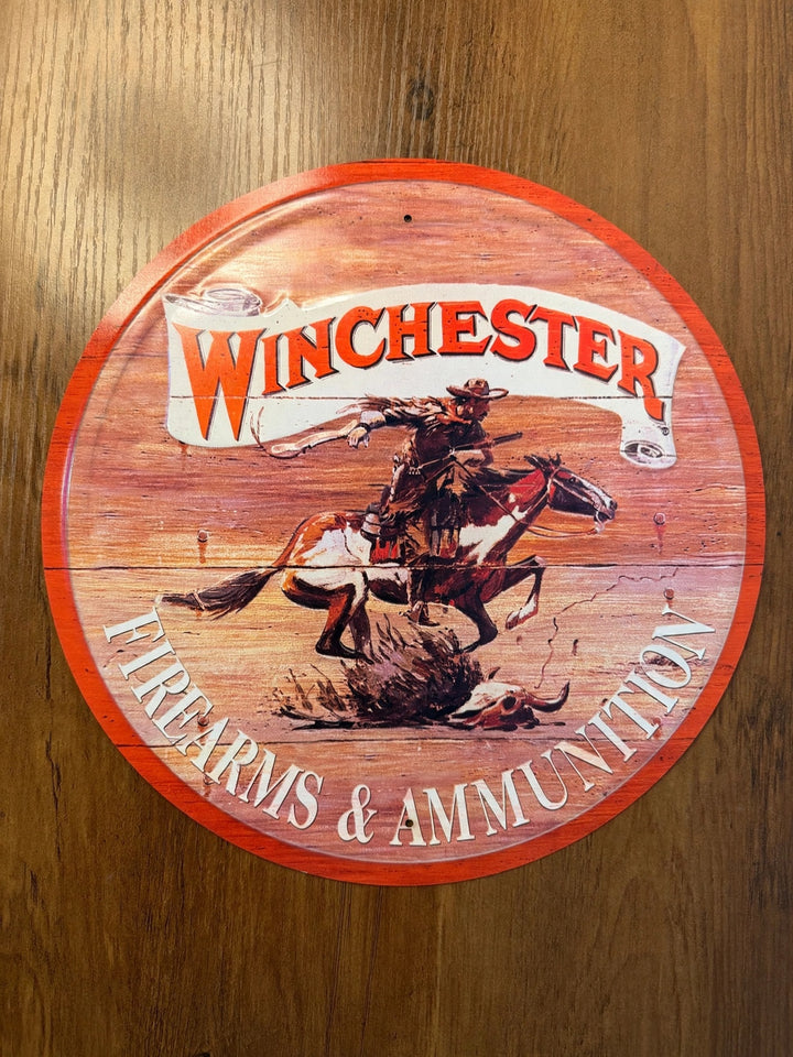 Winchester Firearms and Ammunition round tin sign with cowboy on horseback