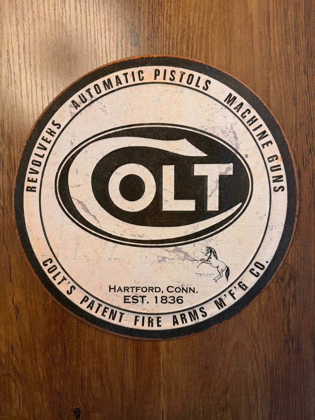 Colt firearms round black and white tin sign
